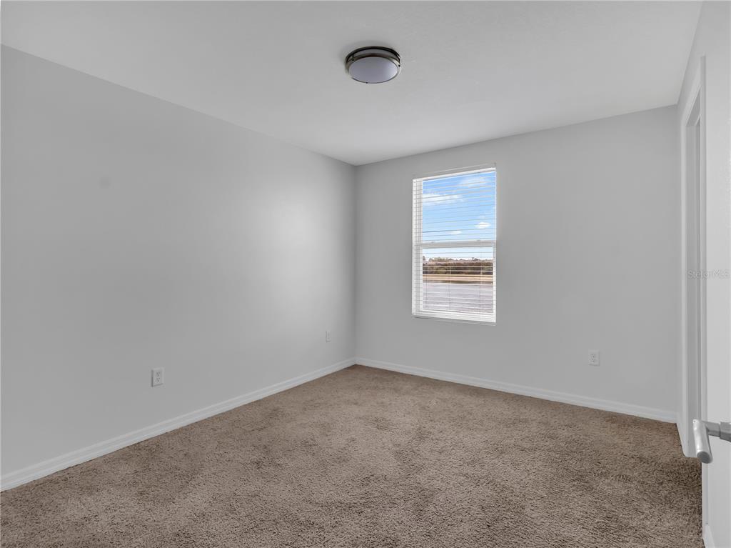 602 Olive Conch Street Ruskin, FL 33570 - Photo 18 of 23 an empty room with a window