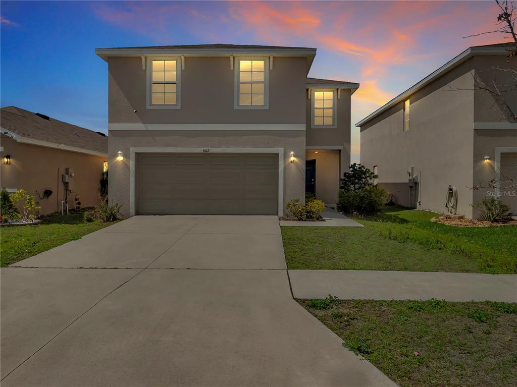 602 Olive Conch Street Ruskin, FL 33570 - Photo 22 of 23 a front view of a house with a yard