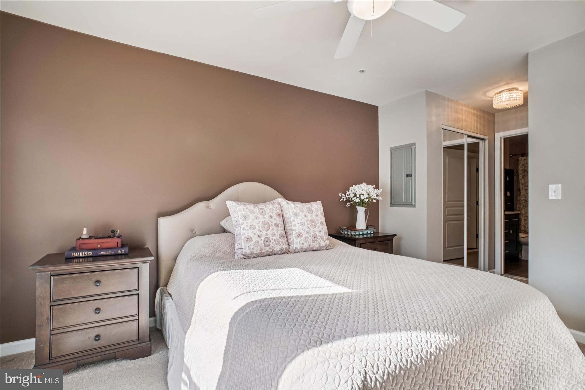 12000 Market Street, Unit 415 Reston, VA 20190 - Photo 13 of 34 a bedroom with a bed and a chandelier