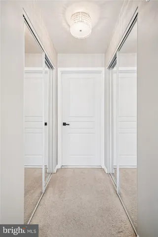 a bathroom with a granite countertop sink a toilet and a mirror