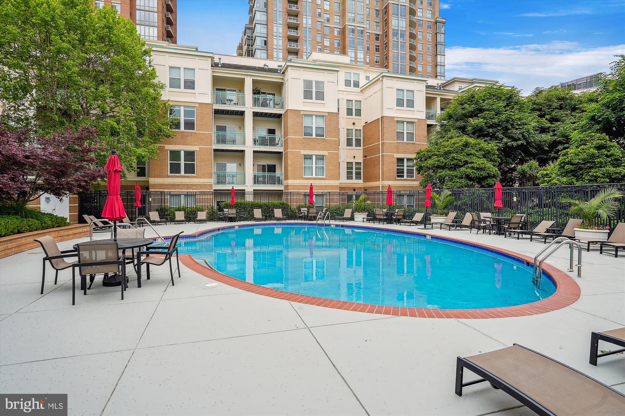 12000 Market Street, Unit 415 Reston, VA 20190 - Photo 32 of 34 a view of a swimming pool with a lounge chairs