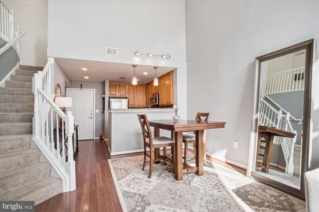 a view of a a dining room with furniture window and wooden floor
