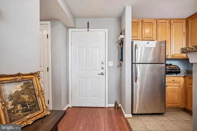 a view of kitchen with furniture refrigerator and window