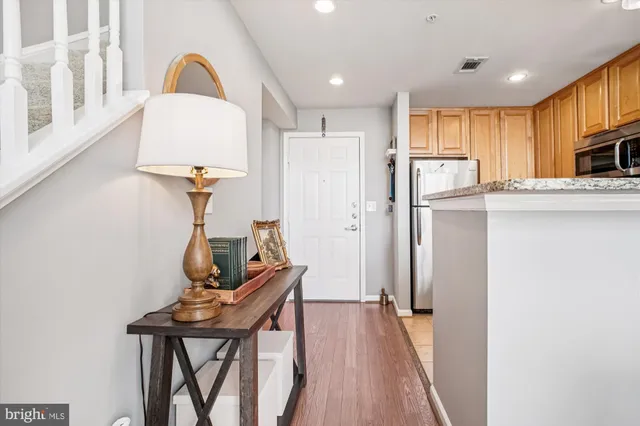 a view of a kitchen with furniture and wooden floor