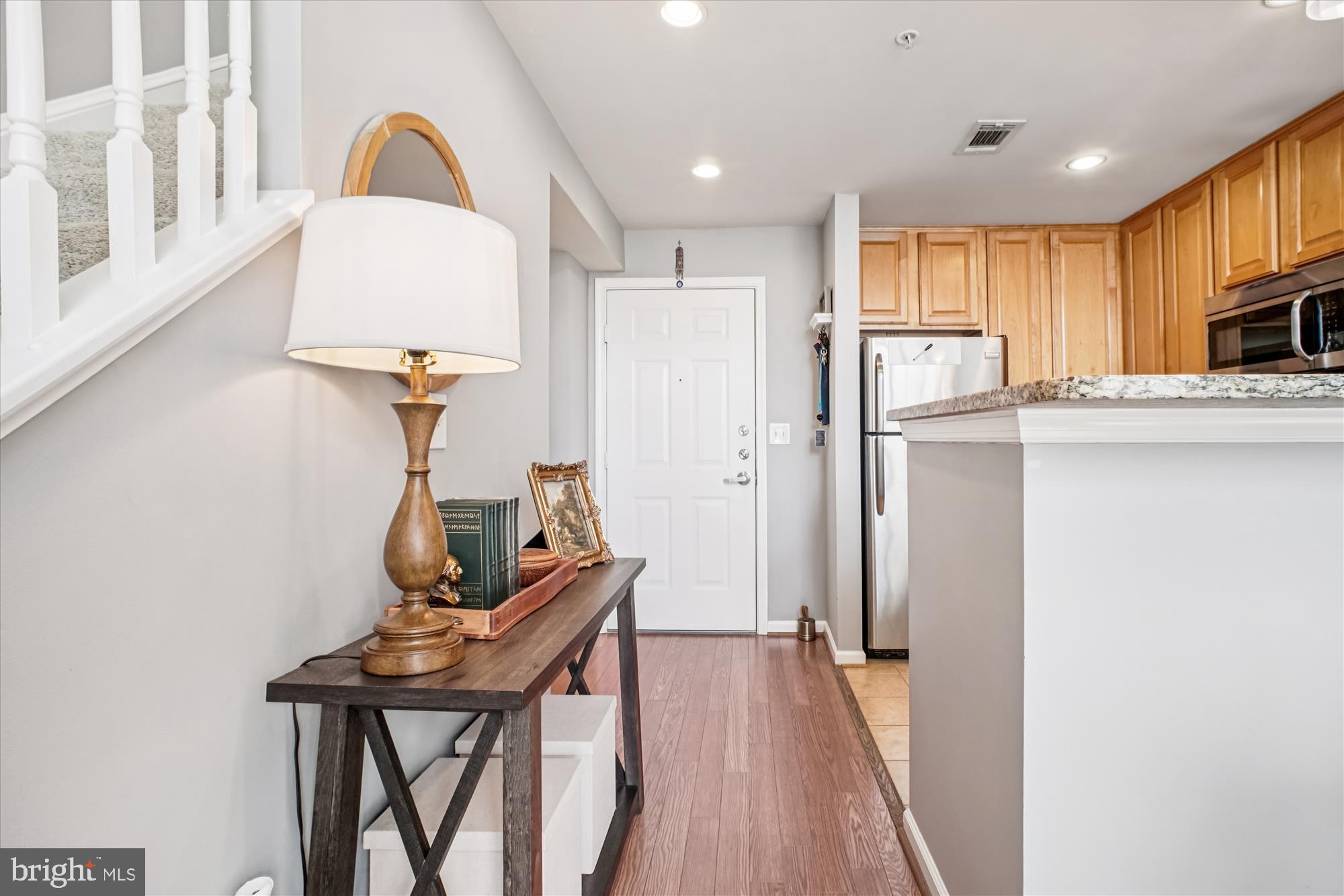 12000 Market Street, Unit 415 Reston, VA 20190 - Photo 8 of 34 a view of a kitchen with furniture and wooden floor