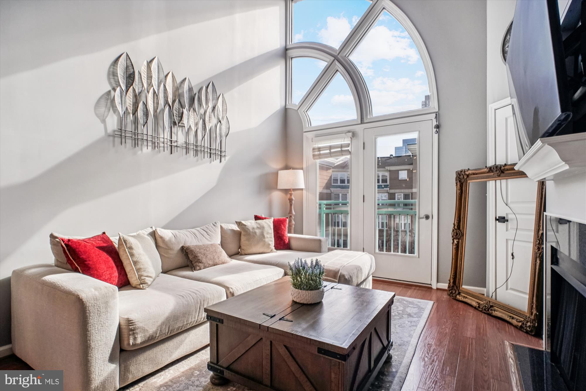 12000 Market Street, Unit 415 Reston, VA 20190 - Photo 9 of 34 a living room with furniture a flat screen tv and a large window