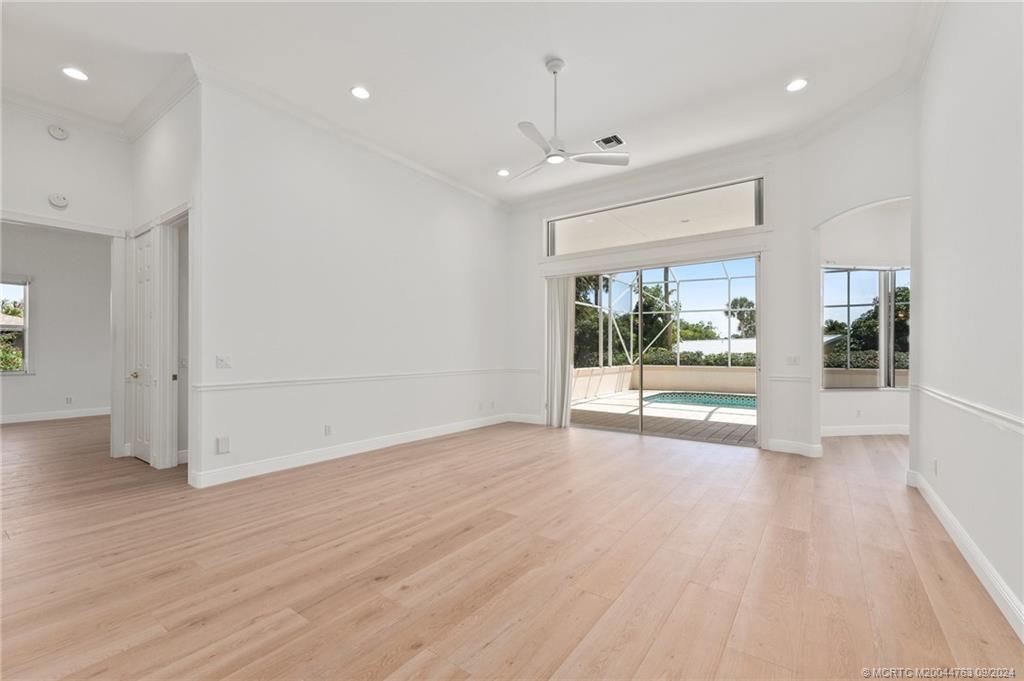 60 North River Road Stuart, FL 34996 - Photo 17 of 74 an empty room with wooden floor and outdoor view