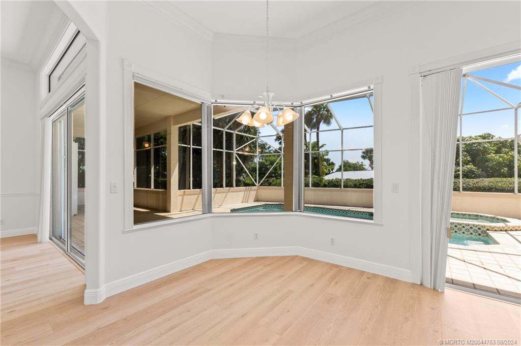 60 North River Road Stuart, FL 34996 - Photo 22 of 74 an empty room with wooden floor and windows