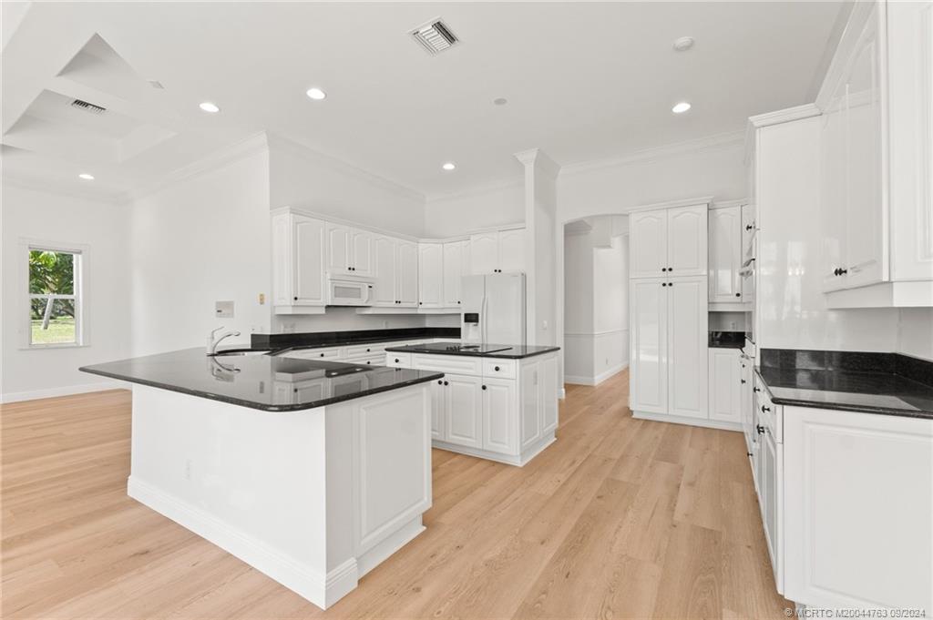 60 North River Road Stuart, FL 34996 - Photo 24 of 74 a kitchen with granite countertop a sink and a stove top oven