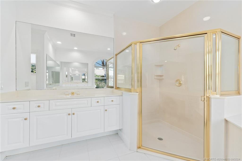 60 North River Road Stuart, FL 34996 - Photo 39 of 74 a bathroom with a shower sink and mirror