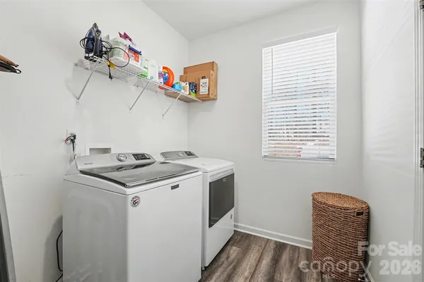 a view of a hallway with wooden floor and closet