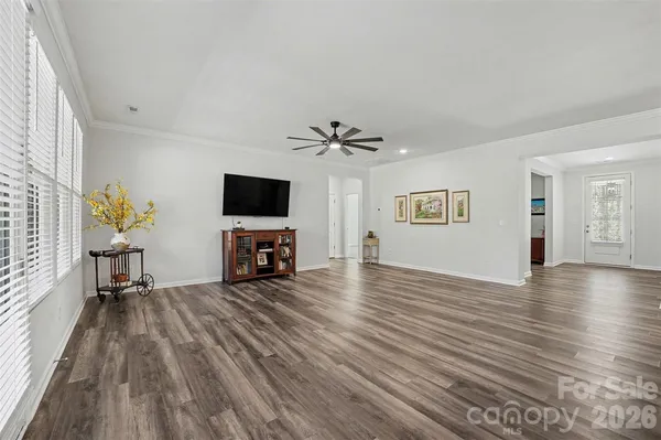a view of a livingroom with furniture and a flat screen tv