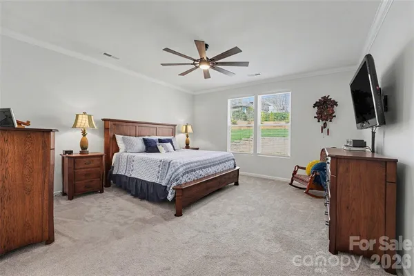 a bedroom with a bed and a flat screen television