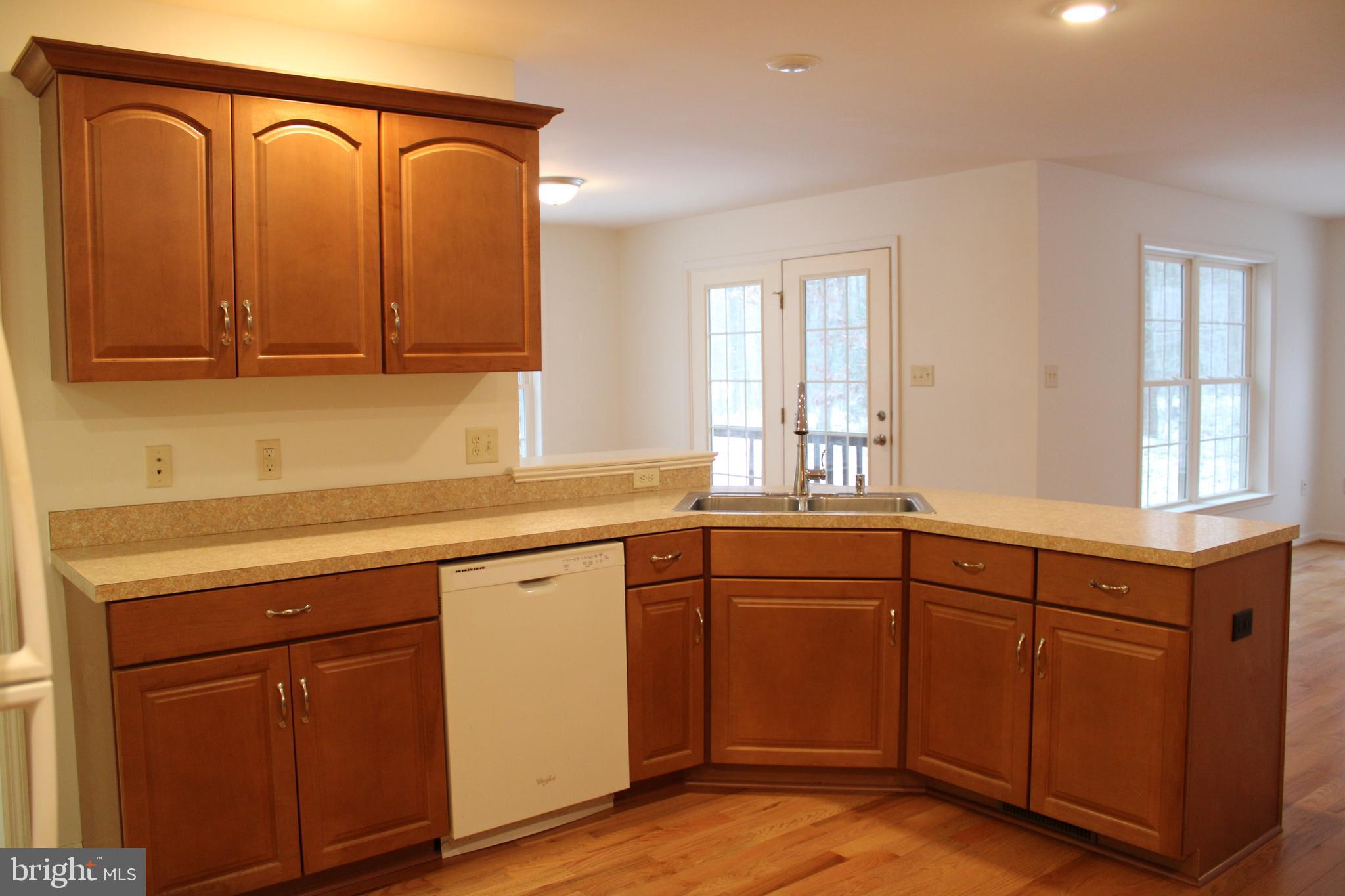 30271 Stonewall Drive Locust Grove, VA 22508 - Photo 10 of 27 a kitchen with stainless steel appliances granite countertop a sink a stove cabinets and wooden floor