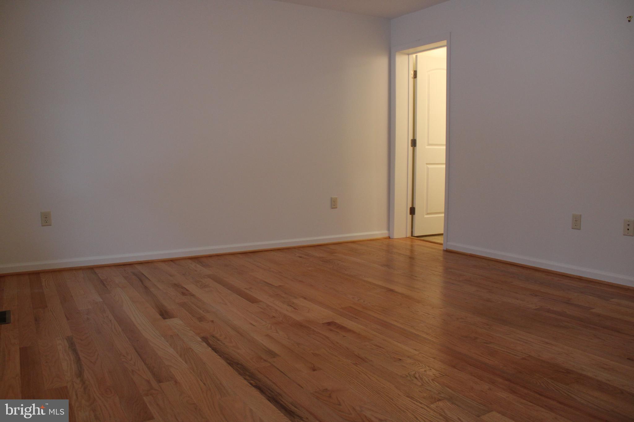 30271 Stonewall Drive Locust Grove, VA 22508 - Photo 13 of 27 an empty room with wooden floor and windows