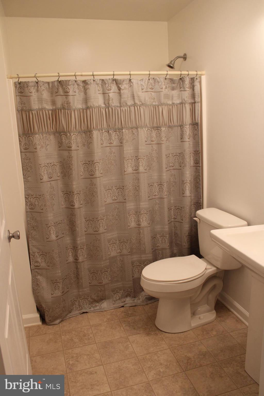 30271 Stonewall Drive Locust Grove, VA 22508 - Photo 20 of 27 a bathroom with a toilet and a shower