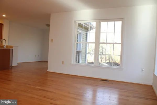 a view of livingroom with hardwood floor and a ceiling fan