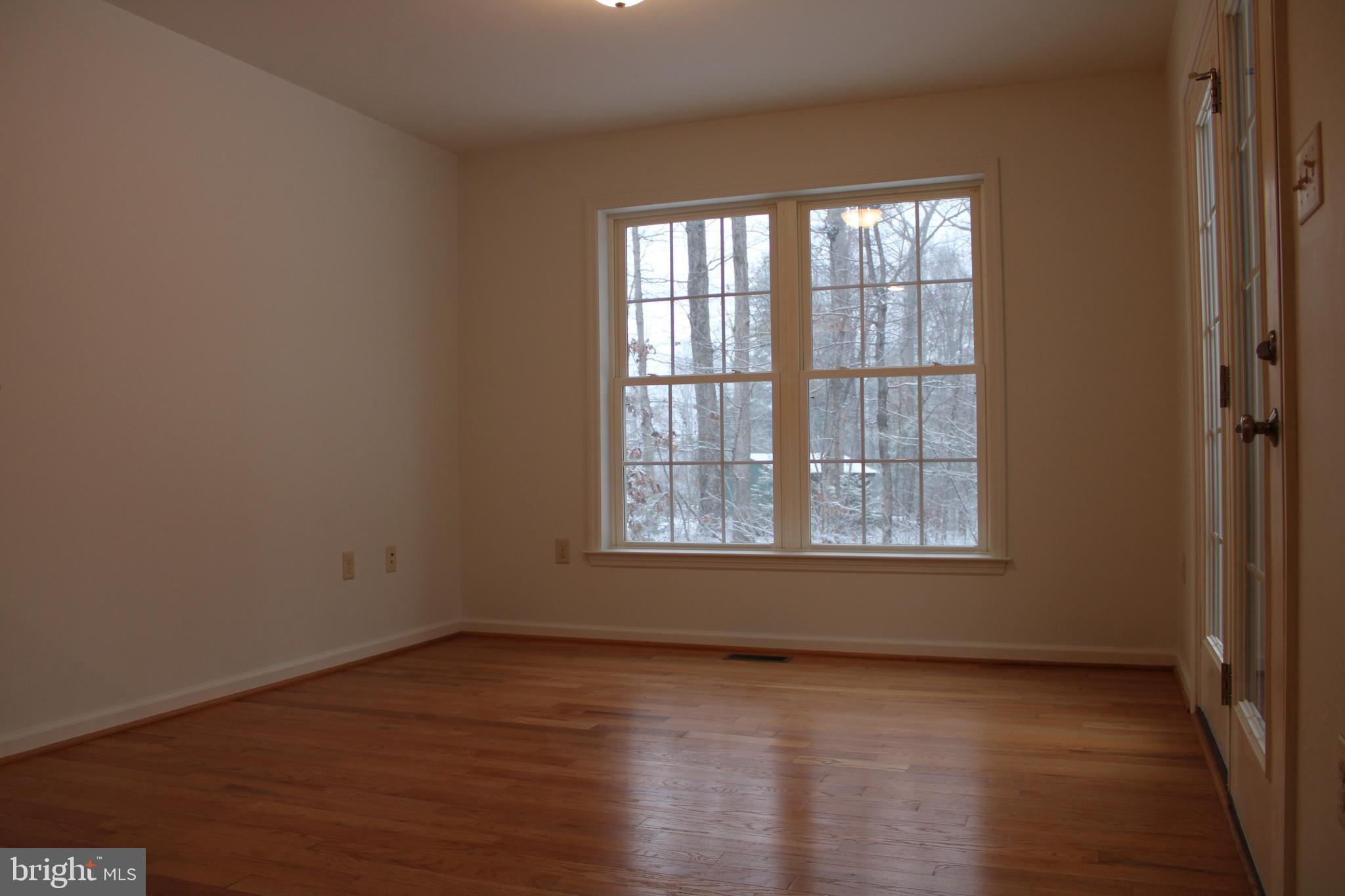 30271 Stonewall Drive Locust Grove, VA 22508 - Photo 6 of 27 an empty room with wooden floor and windows