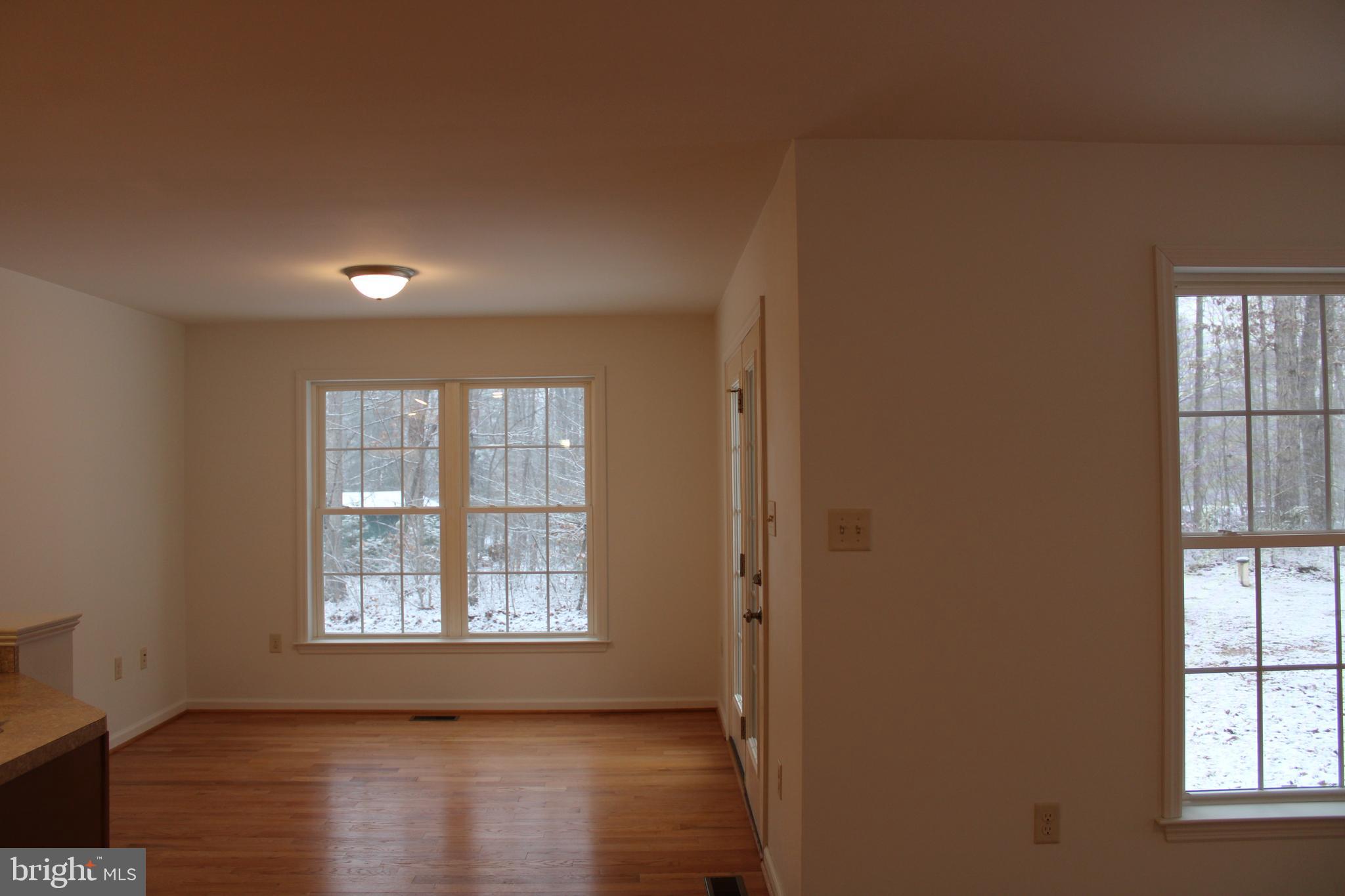 30271 Stonewall Drive Locust Grove, VA 22508 - Photo 7 of 27 a view of an empty room with wooden floor and a window