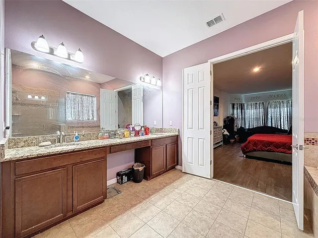 a bedroom with bed and a couch