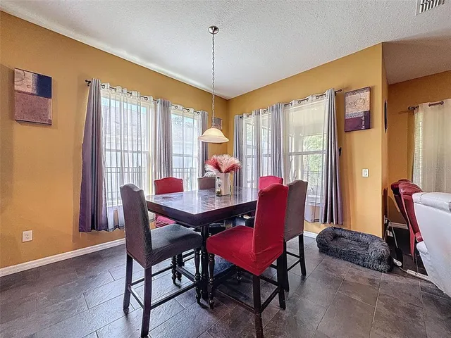 a living room with furniture a flat screen tv and a window