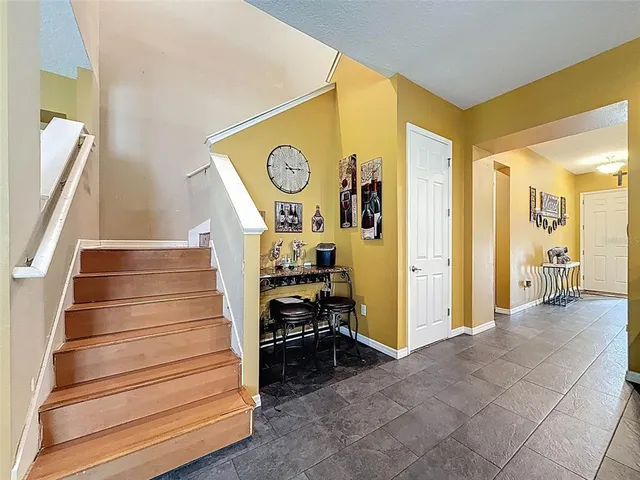 a large kitchen with granite countertop lots of counter top space and stainless steel appliances