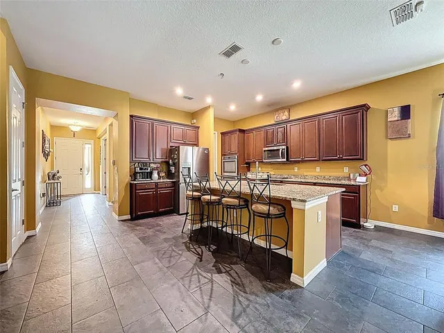 a view of a hallway with wooden floor and stairs