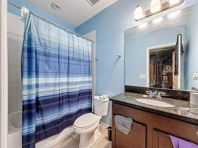 a aerial view of a house with a big yard plants and large trees