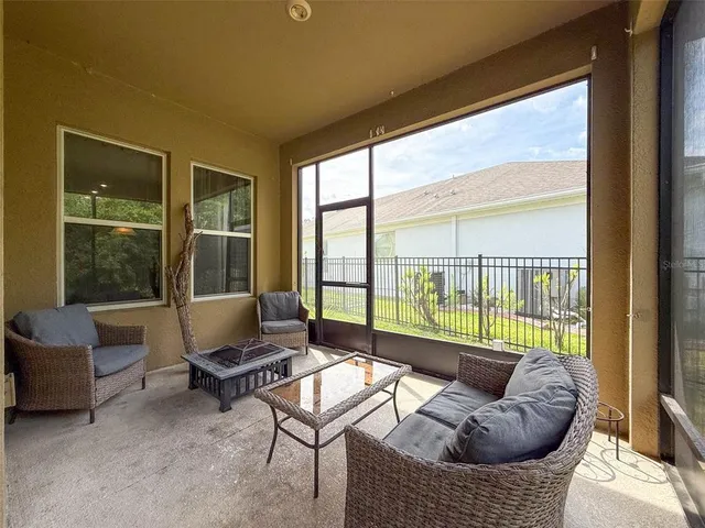 an aerial view of a house with a yard and lake view