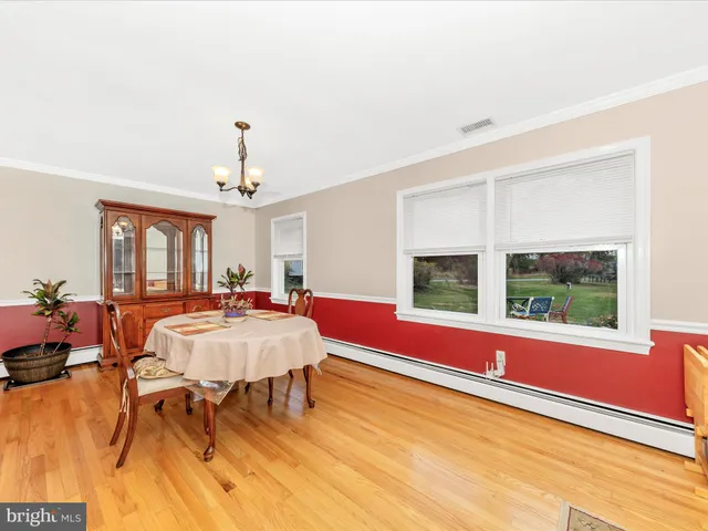 a living room with furniture fireplace and a large window