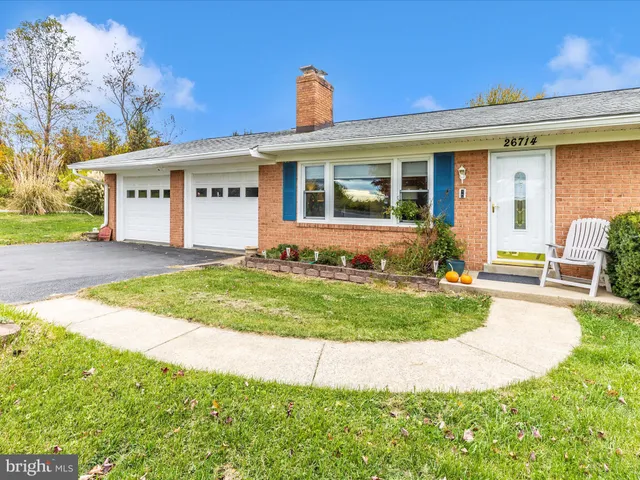 a front view of house with yard and outdoor seating