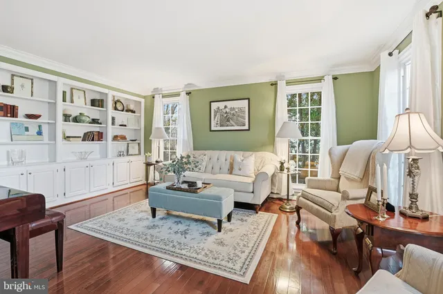 a living room with furniture and floor to ceiling windows