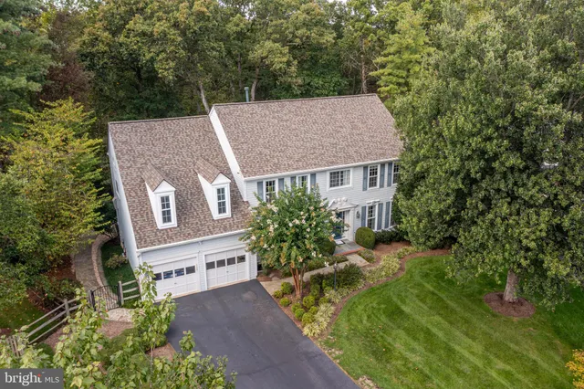 a kitchen with kitchen island granite countertop wooden cabinets a sink and a stove