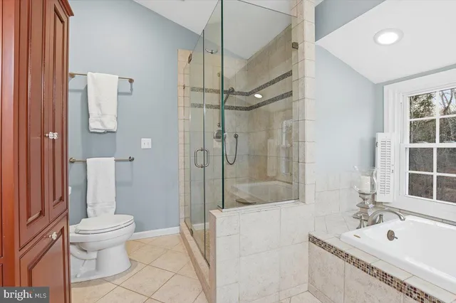 a spacious bedroom with a bed and a chandelier