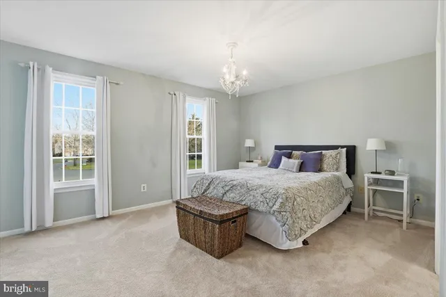 a bed room with a bed and a chandelier