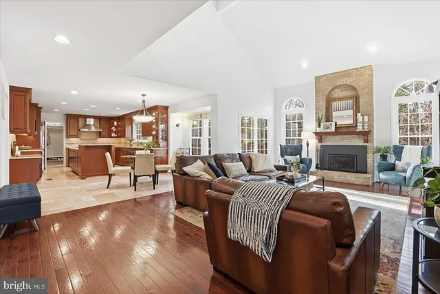 a dining room with furniture potted plants and wooden floor