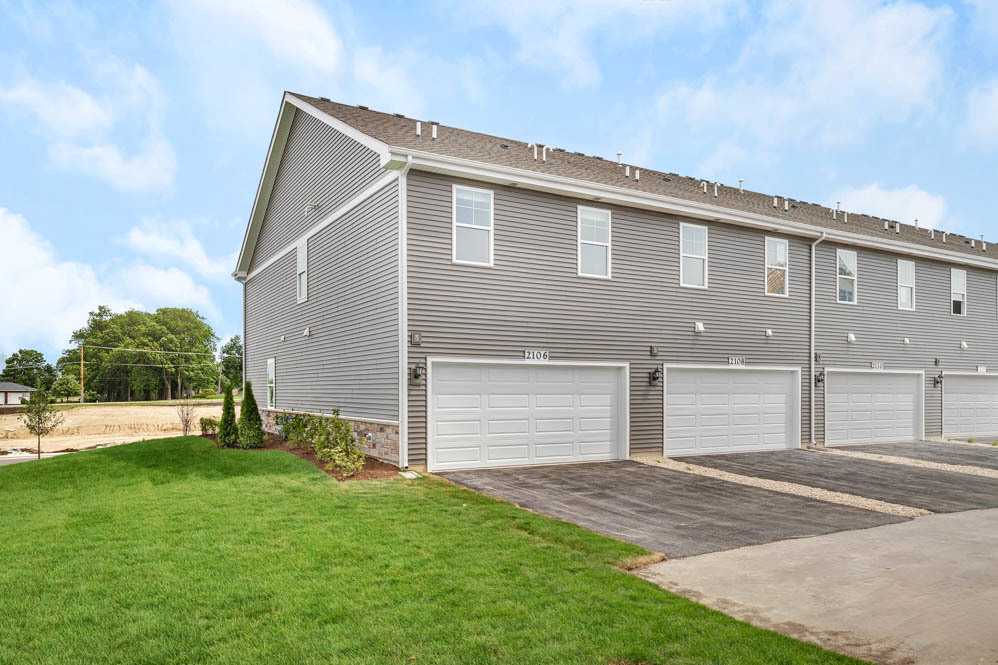 2242 Bodega Road Oswego, IL 60543 - Photo 20 of 23 a front view of a house with a yard and garage