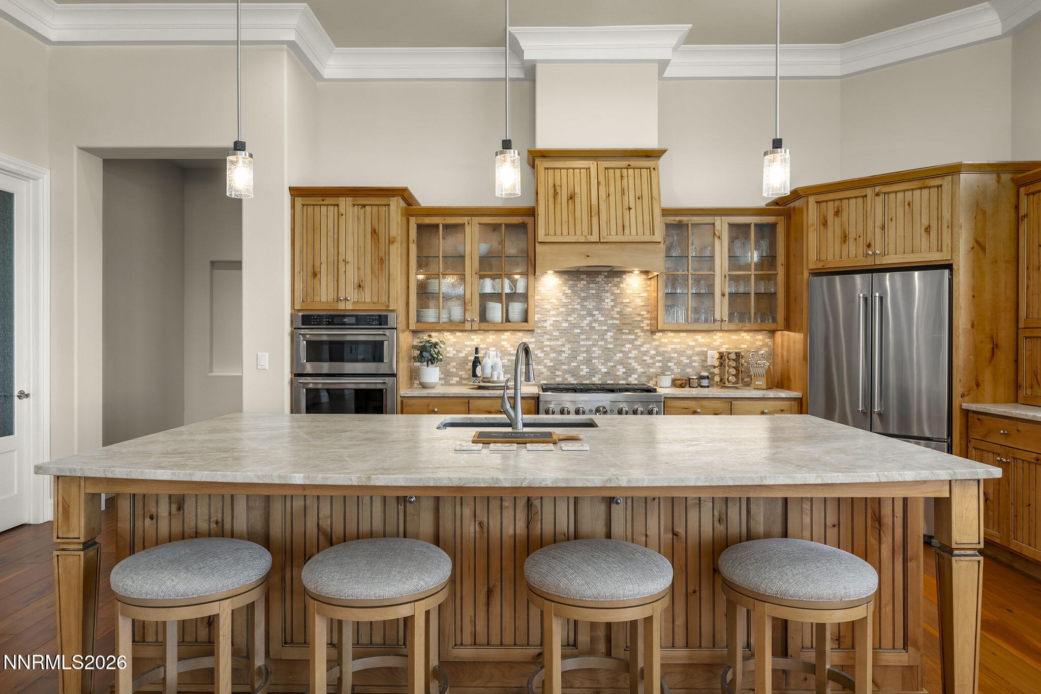 342 James Canyon Loop Genoa, NV 89411 - Photo 14 of 51 a kitchen with stainless steel appliances a table and chairs