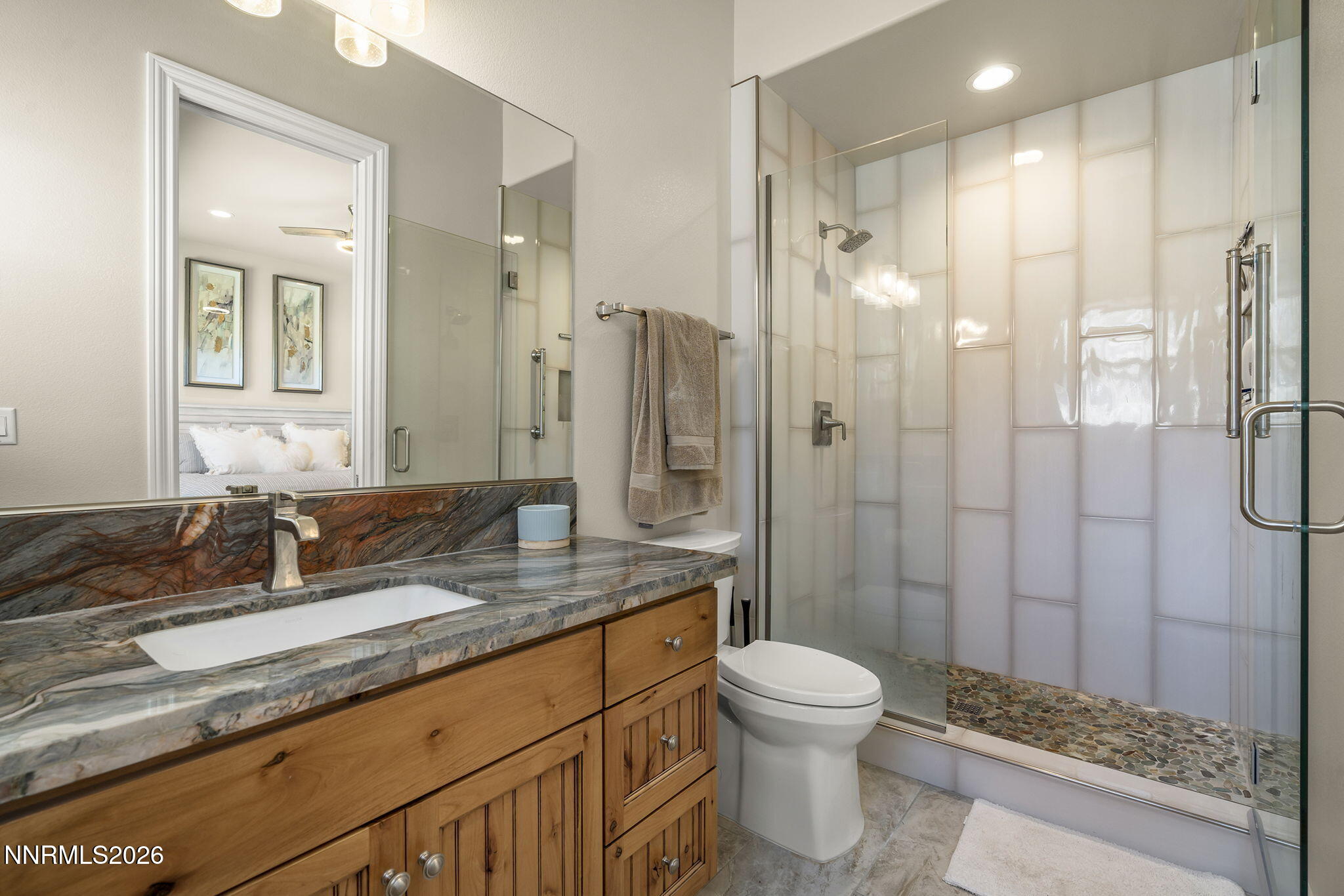 342 James Canyon Loop Genoa, NV 89411 - Photo 27 of 51 a bathroom with a granite countertop sink toilet a mirror and shower