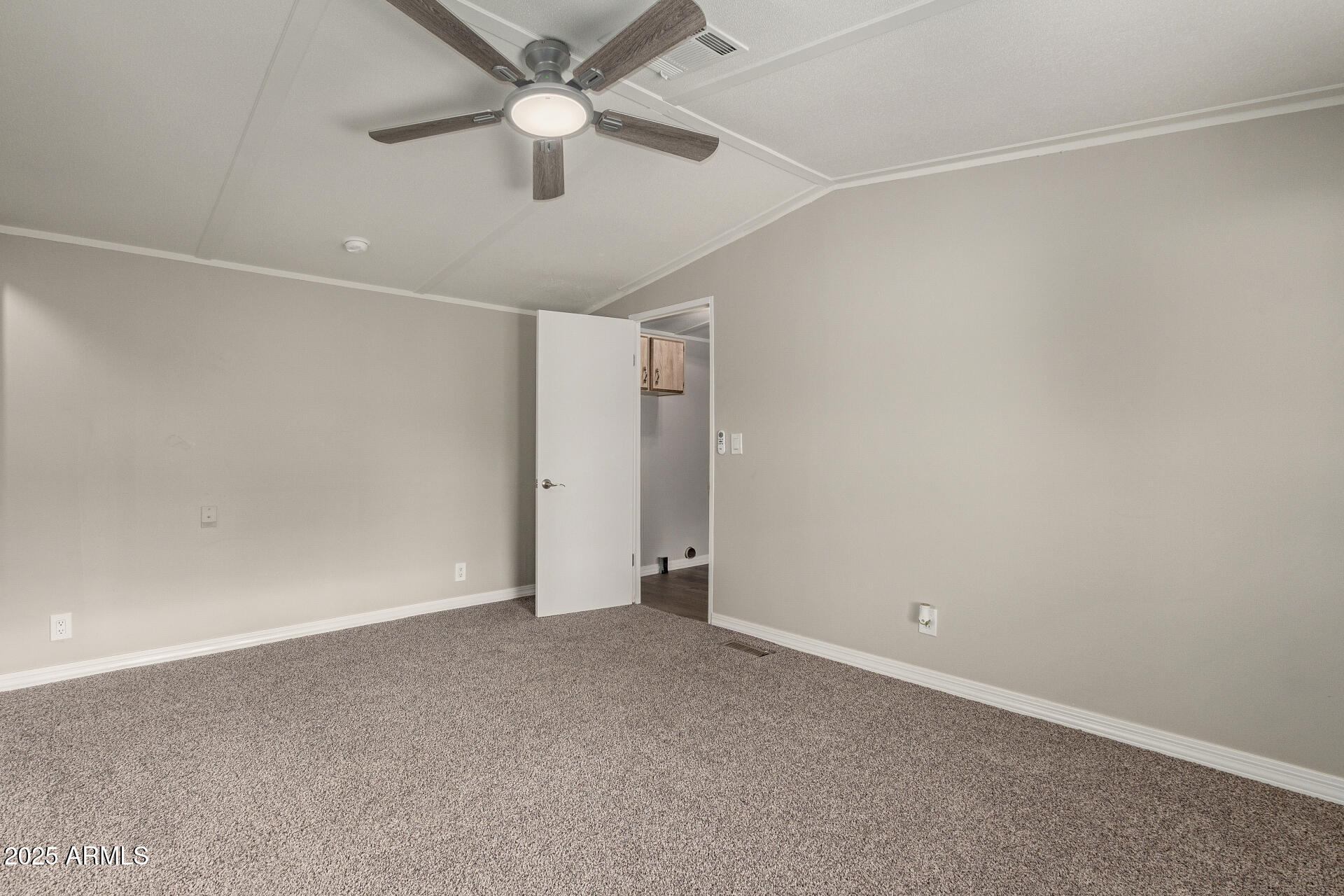 1730 East 21st Avenue Apache Junction, AZ 85119 - Photo 12 of 25 an empty room with a ceiling fan and a ceiling fan