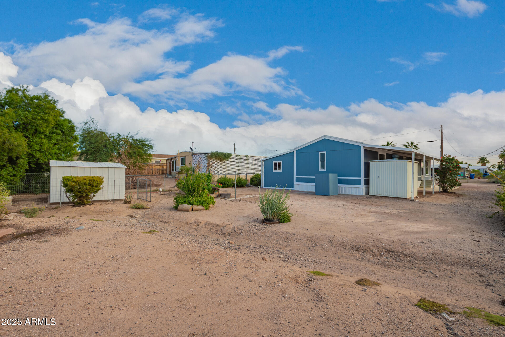1730 East 21st Avenue Apache Junction, AZ 85119 - Photo 24 of 25 a front view of a house with a yard and garage