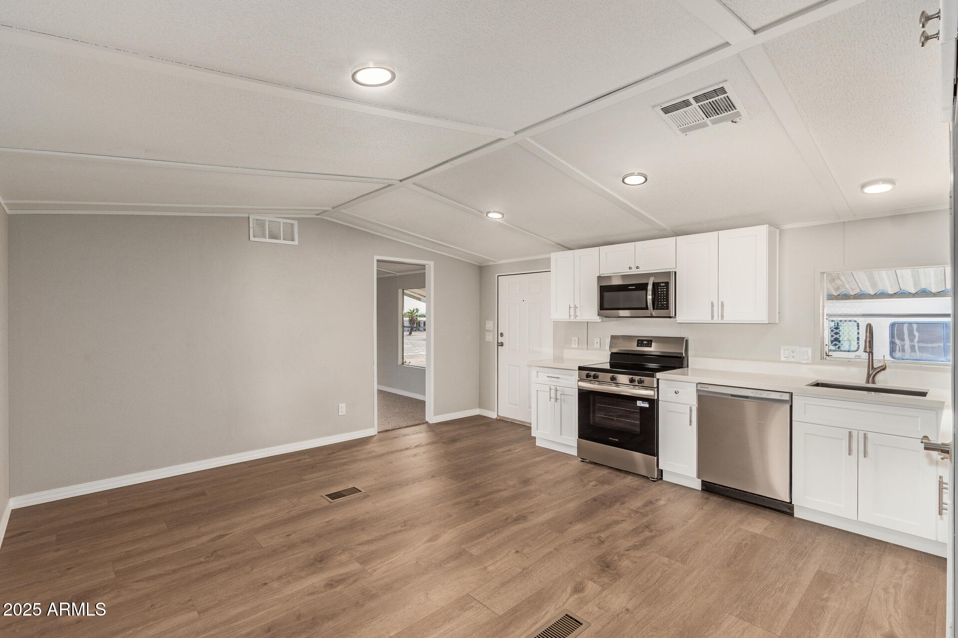 1730 East 21st Avenue Apache Junction, AZ 85119 - Photo 5 of 25 a large kitchen with stainless steel appliances granite countertop a stove and a refrigerator