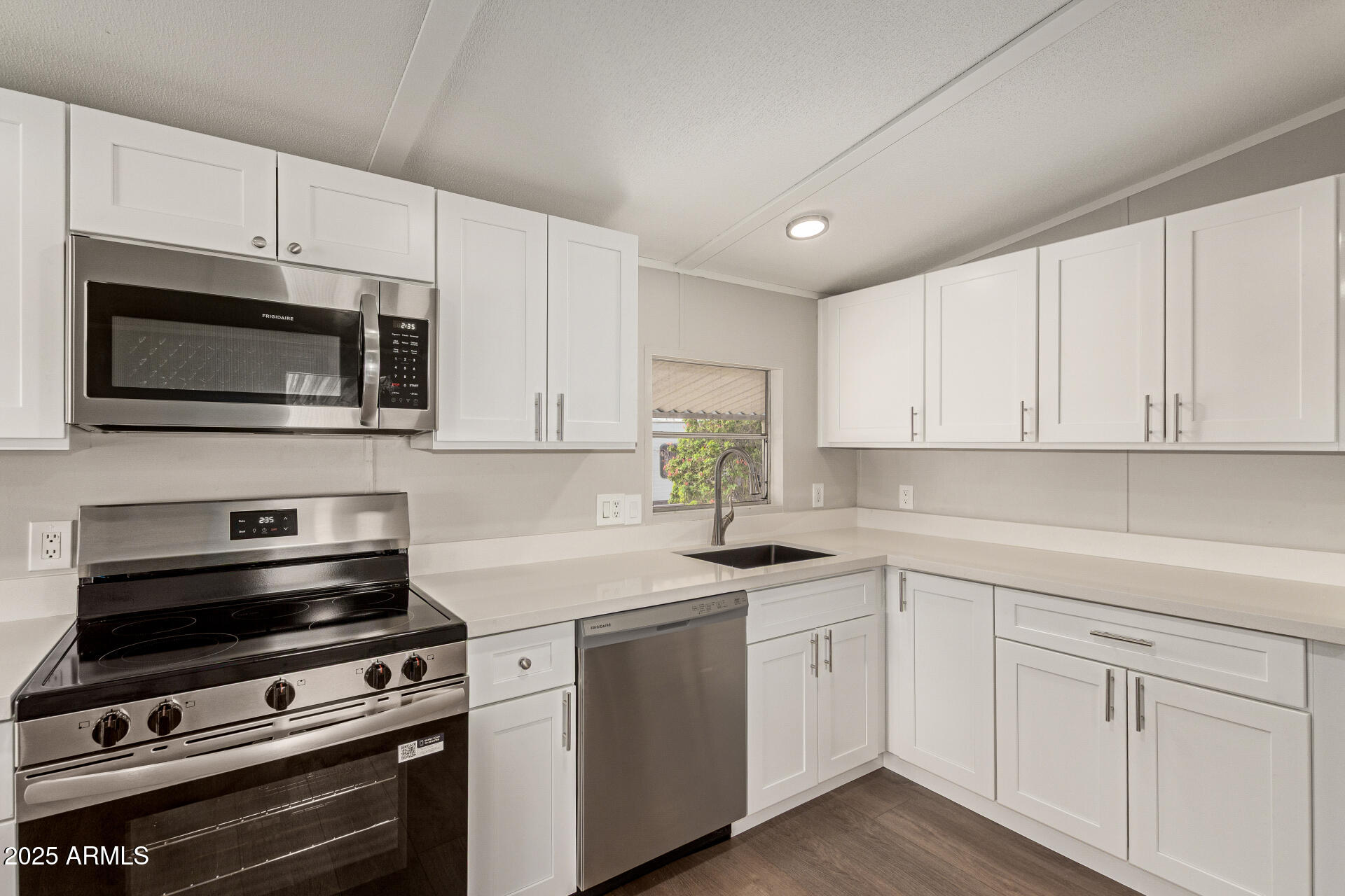 1730 East 21st Avenue Apache Junction, AZ 85119 - Photo 10 of 25 a kitchen with cabinets stainless steel appliances and a counter space