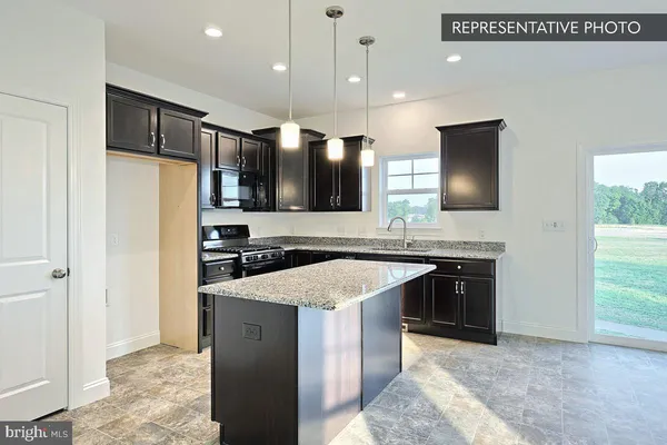 a kitchen with a sink stove and microwave