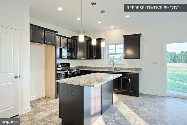 a kitchen with a sink stove and microwave