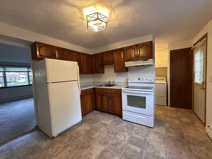 a kitchen with a refrigerator sink and stove