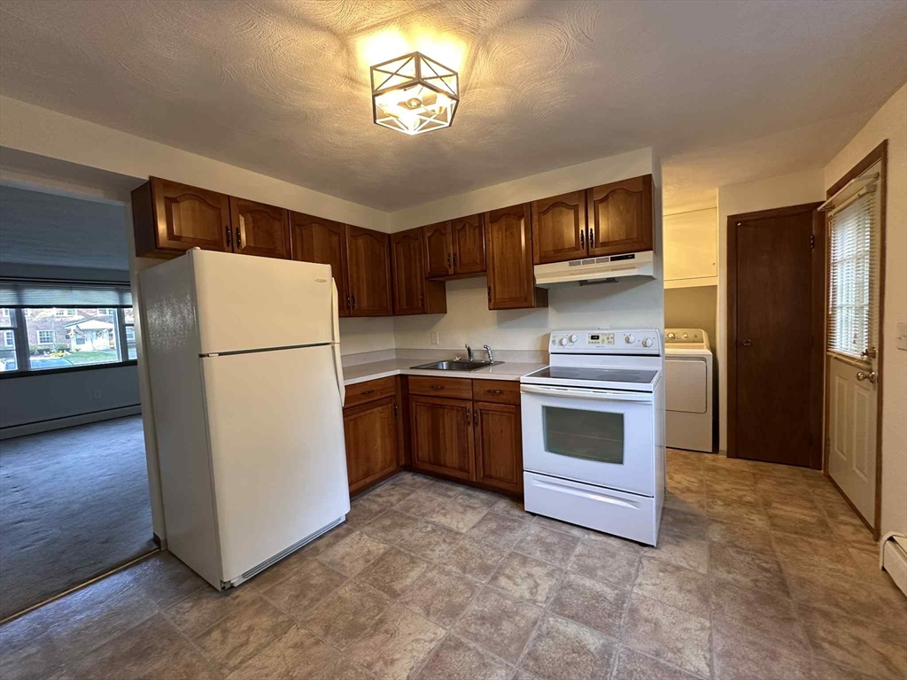 96 Coventry Circle, Unit 96 Brockton, MA 02301 - Photo 3 of 13 a kitchen with a refrigerator sink and stove
