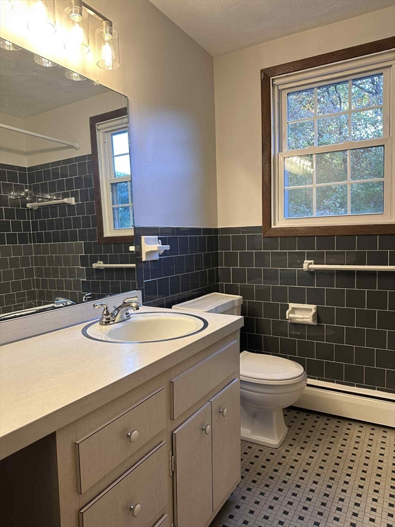 96 Coventry Circle, Unit 96 Brockton, MA 02301 - Photo 8 of 13 a bathroom with a sink toilet vanity and mirror
