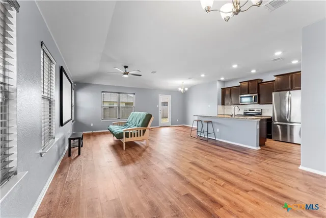 a living room with furniture and a wooden floor