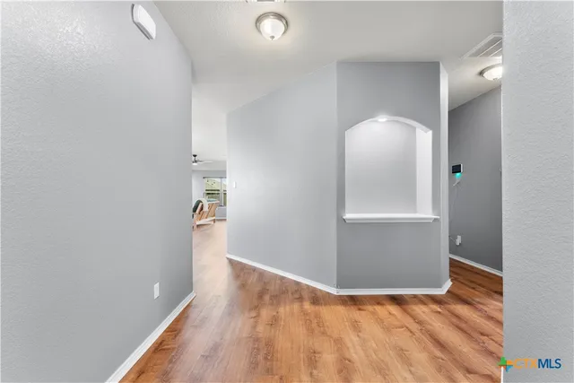 a view of a house with a yard and a tree